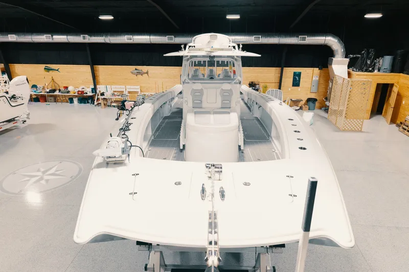 Slide: The Image of 2023 Freeman 42LR boat in a spacious indoor showroom setting. - 51