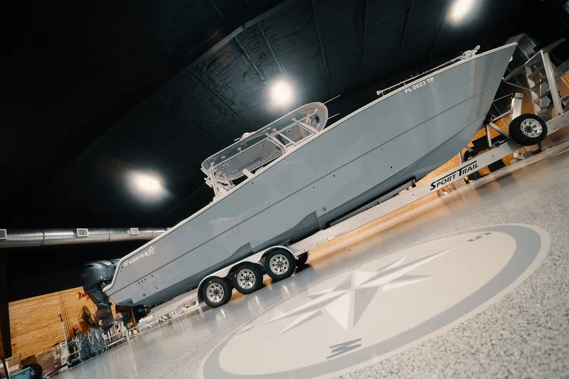 Slide: The Image of 2023 Freeman 42LR boat on trailer in indoor showroom setting. - 35