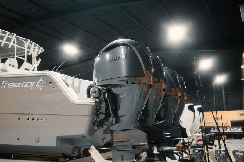 Slide: The Image of Freeman 42LR 2023 boat with Yamaha outboard engines in a workshop setting. - 27