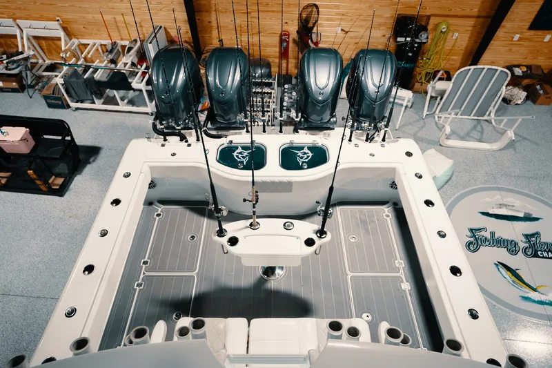 Slide: The Image of Freeman 42LR 2023 fishing boat with multiple rods and engines in a garage setting. - 58
