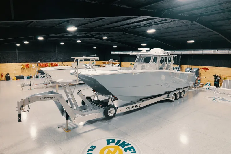 Slide: The Image of 2023 Freeman 42LR boat on trailer in indoor showroom. - 21
