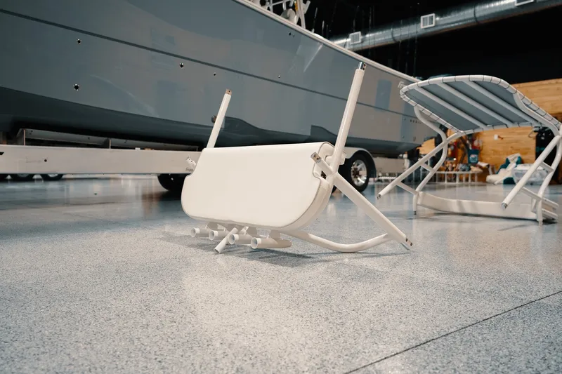 Slide: The Image of Freeman 42LR boat trailer with folded seats on a polished showroom floor, 2023 model. - 93