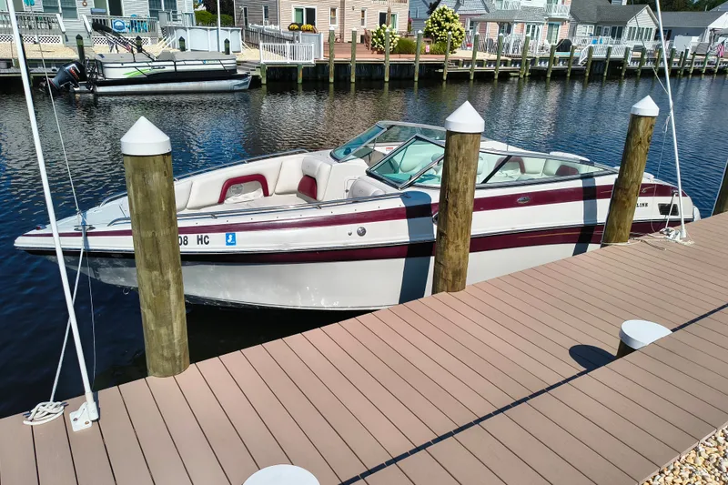 The Image of 2004 Crownline 270 BR boat docked in a serene waterfront setting. - 5
