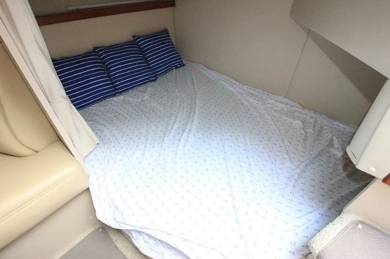 Slide: The Image of Interior cabin of 2001 Cruisers Yachts 2870 Express with bed and striped pillows. - 22