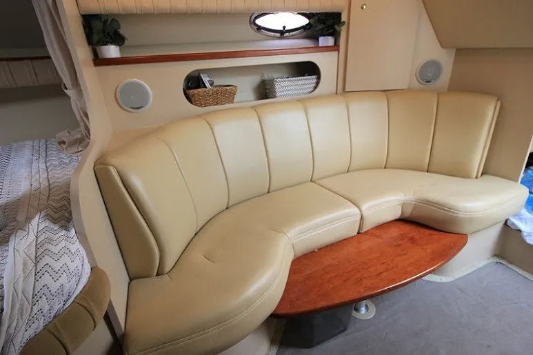 Slide: The Image of Interior of 2001 Cruisers Yachts 2870 Express with beige seating and wooden table. - 18