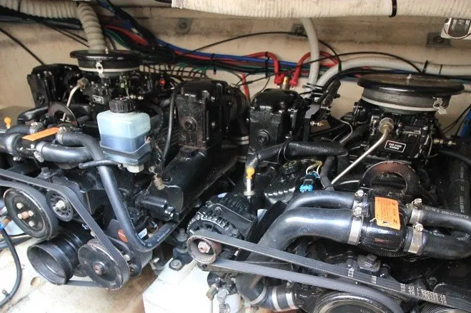 Slide: The Image of Engine compartment of 2001 Cruisers Yachts 2870 Express, showcasing dual engines and wiring. - 23