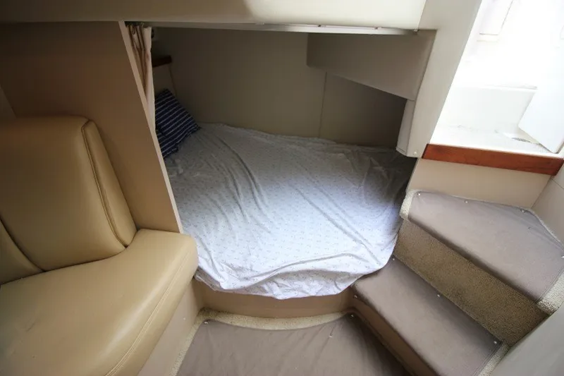 Slide: The Image of 2001 Cruisers Yachts 2870 Express cabin interior with bed and seating area. - 20