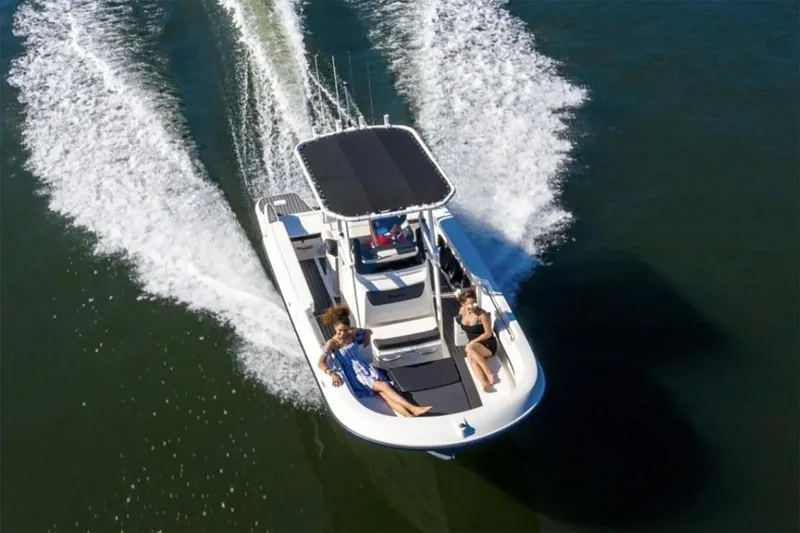 Slide: The Image of Manufacturer Provided Image: 2025 Bayliner Trophy T22CC boat cruising with passengers on open water. - 1