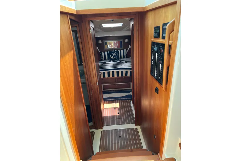 Slide: The Image of 2019 Back Cove 41 yacht interior with nautical-themed bedroom and wooden paneling. - 10