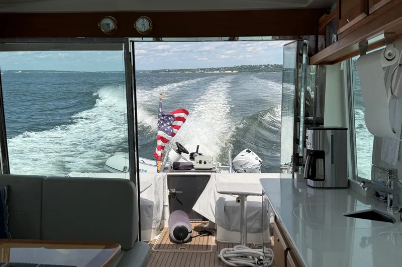 Slide: The Image of Interior view of 2019 Back Cove 41 yacht with ocean wake and American flag. - 4