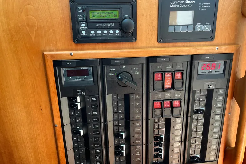 Slide: The Image of Electrical control panel of a 2019 Back Cove 41 boat, featuring Cummins Onan marine generator. - 15