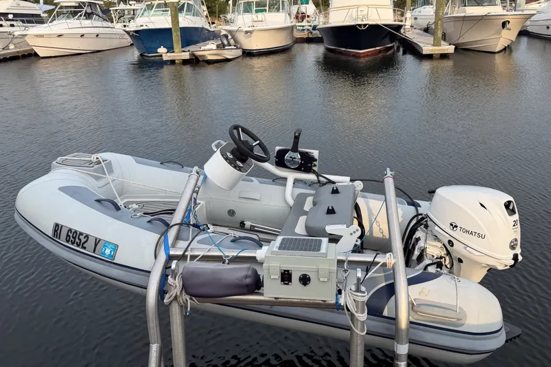Slide: The Image of Inflatable boat with Tohatsu motor docked near Back Cove 41 yachts, 2019 model. - 14