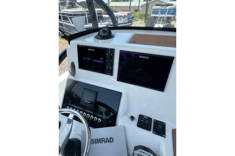 Slide: The Image of 2018 Sea Pro 248 Bay boat dashboard with Simrad navigation displays. - 16