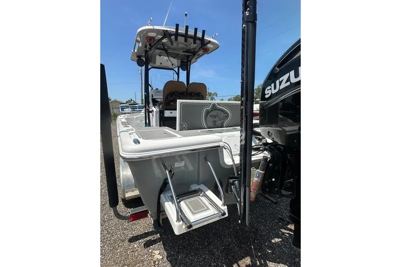 Slide: The Image of 2018 Sea Pro 248 Bay boat with Suzuki engine, rear view showing ladder and fishing rod holders. - 8