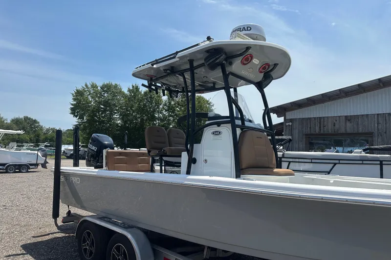 Slide: The Image of 2018 Sea Pro 248 Bay boat on trailer, parked outdoors under clear sky. - 1