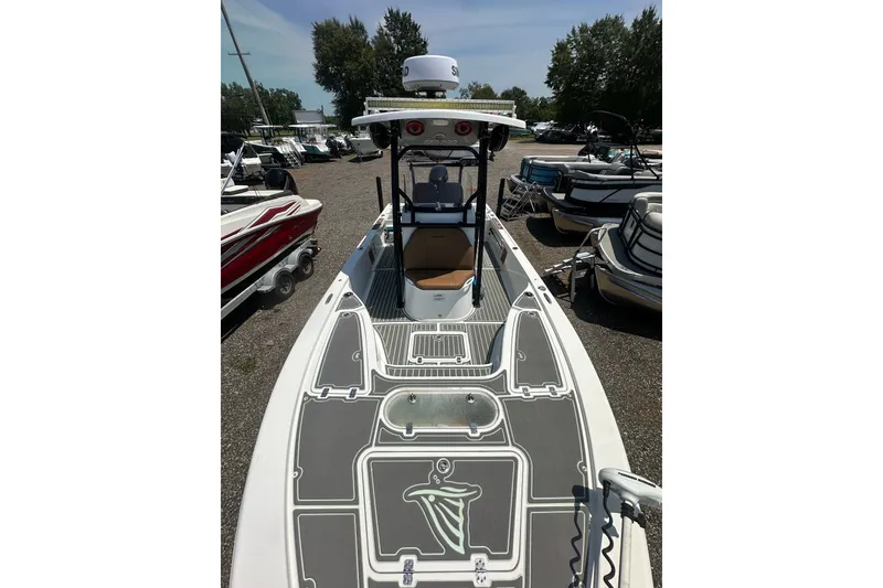 Slide: The Image of 2018 Sea Pro 248 Bay boat in a marina, surrounded by other vessels. - 24
