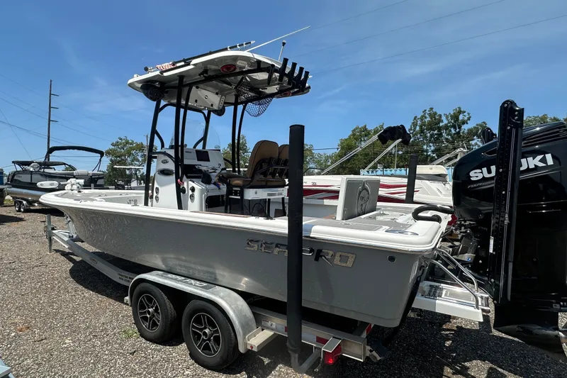 Slide: The Image of 2018 Sea Pro 248 Bay boat on trailer, equipped with Suzuki outboard motor. - 10