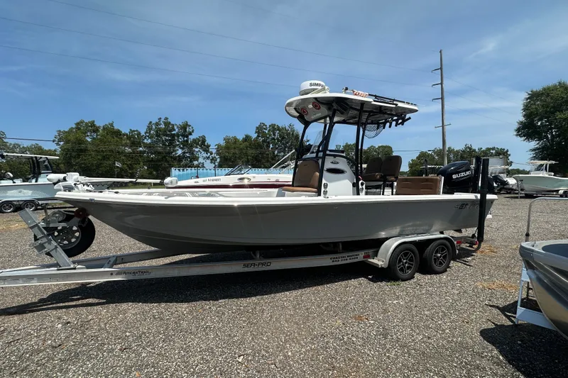 Slide: The Image of 2018 Sea Pro 248 Bay boat on trailer, parked outdoors under clear sky. - 11