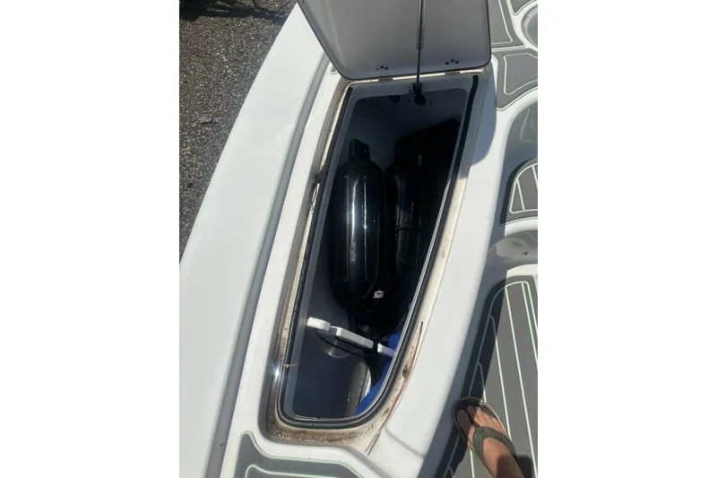 Slide: The Image of Open storage compartment on a 2018 Sea Pro 248 Bay boat, showing interior contents. - 38