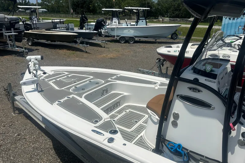 Slide: The Image of 2018 Sea Pro 248 Bay boat on display in a marina with other boats. - 34