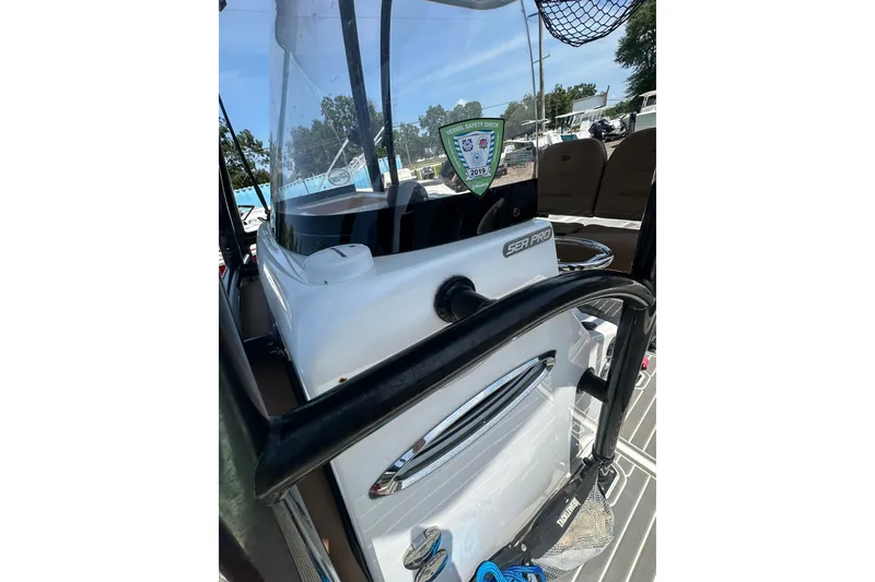 Slide: The Image of 2018 Sea Pro 248 Bay boat console with safety decal and visible seating area. - 27