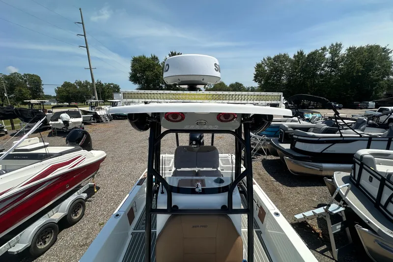 Slide: The Image of 2018 Sea Pro 248 Bay boat in a marina, surrounded by other boats. - 25