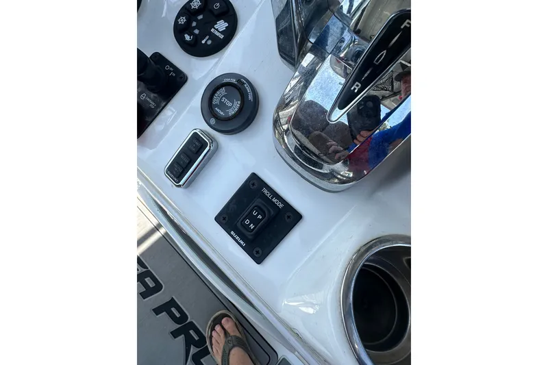 Slide: The Image of Control panel of a 2018 Sea Pro 248 Bay boat with various switches and controls. - 19