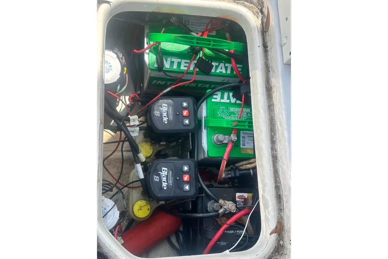 Slide: The Image of 2018 Sea Pro 248 Bay boat battery compartment with Interstate batteries and wiring. - 40