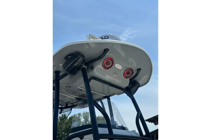 Slide: The Image of 2018 Sea Pro 248 Bay boat with T-top and mounted lights under clear sky. - 2
