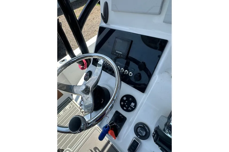 Slide: The Image of Steering console of a 2018 Sea Pro 248 Bay boat with controls and gauges. - 20