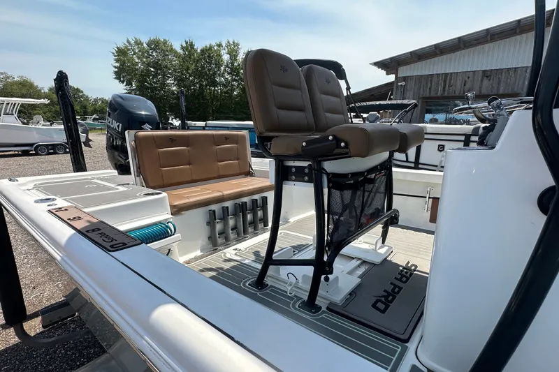Slide: The Image of 2018 Sea Pro 248 Bay boat interior with seating and fishing rod holders. - 3
