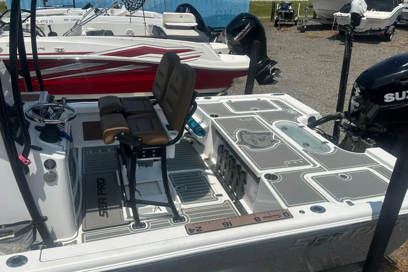 Slide: The Image of 2018 Sea Pro 248 Bay boat interior with seating and fishing equipment. - 42