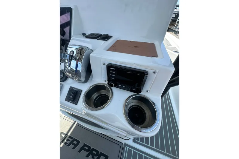 Slide: The Image of Control panel of a 2018 Sea Pro 248 Bay boat with cup holders and audio system. - 32