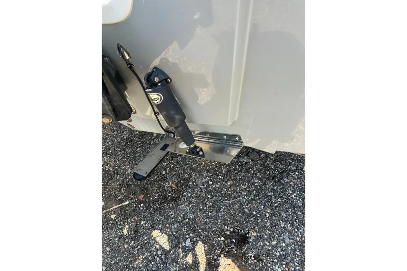 Slide: The Image of 2018 Sea Pro 248 Bay boat trim tab mechanism on asphalt surface. - 6