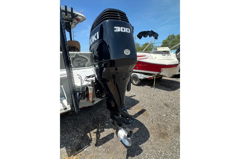 Slide: The Image of 2018 Sea Pro 248 Bay with Suzuki 300 outboard motor in a boatyard. - 9