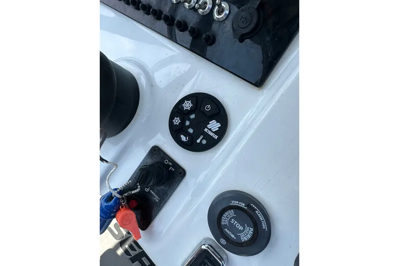 Slide: The Image of Control panel of a 2018 Sea Pro 248 Bay boat with various switches and buttons. - 18