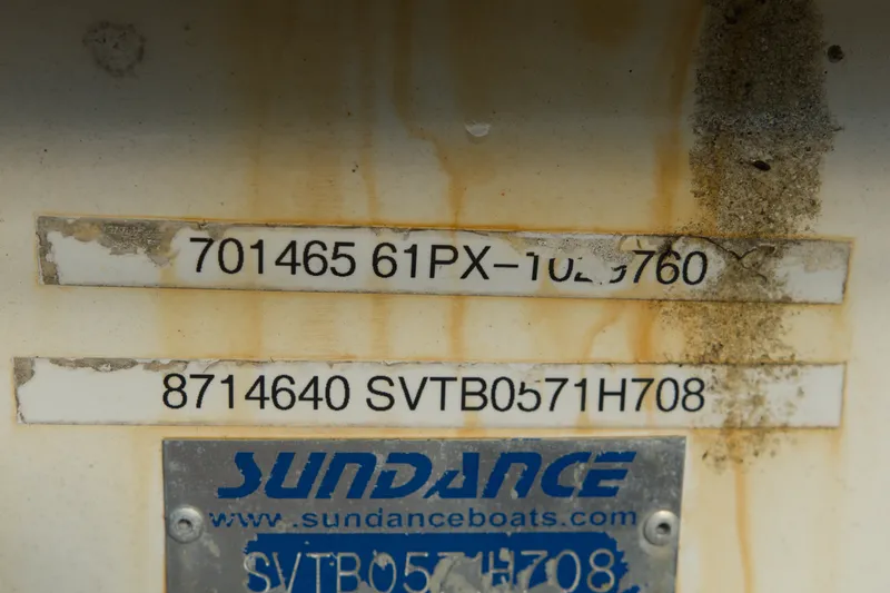 Slide: The Image of Sundance B20CCR 2008 boat identification numbers with visible wear and rust stains. - 10