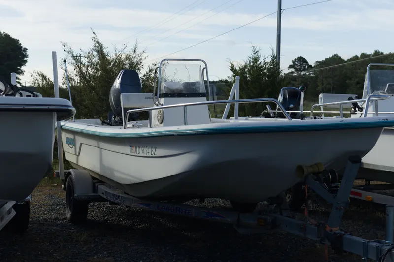 Slide: The Image of 2008 Sundance B20CCR boat on trailer, parked outdoors with trees in background. - 3