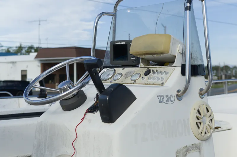 Slide: The Image of Console of a 2008 Sundance B20CCR boat with steering wheel and controls. - 5