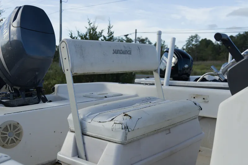 Slide: The Image of 2008 Sundance B20CCR boat seat with visible wear and Yamaha motor in background. - 6