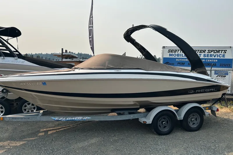 Slide: The Image of 2011 Regal 2100 Bowrider boat on trailer at Seattle Water Sports service center. - 1
