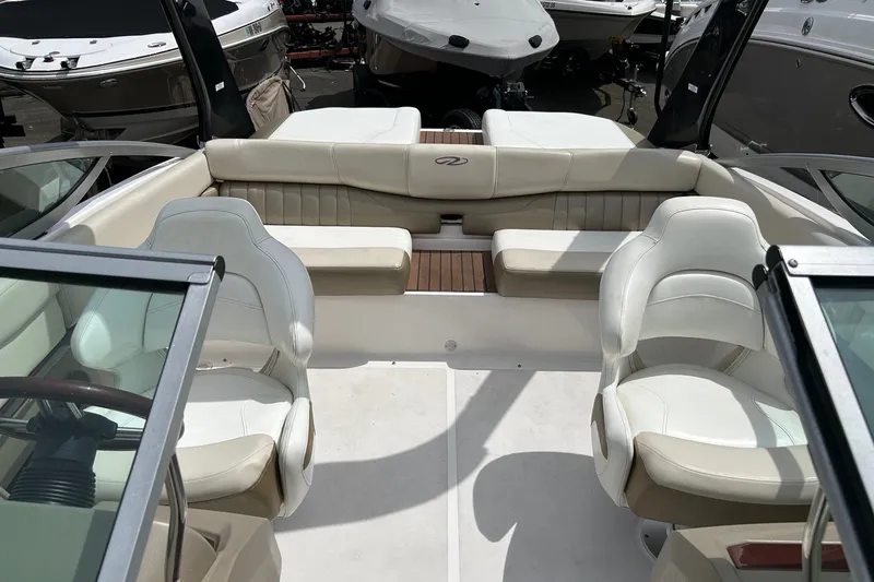 Slide: The Image of 2011 Regal 2100 Bowrider interior with white seating and sleek design. - 9