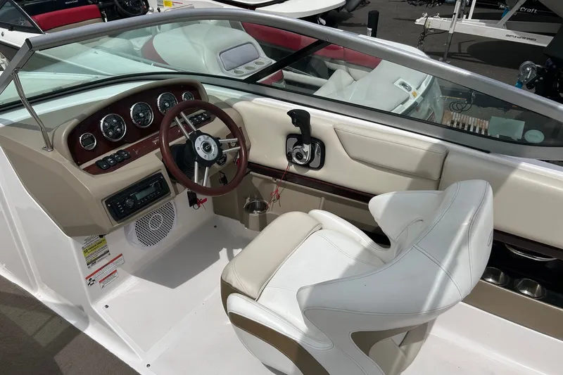Slide: The Image of 2011 Regal 2100 Bowrider cockpit with steering wheel and dashboard controls. - 5