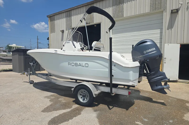 Slide: The Image of 2018 Robalo R180 Center Console boat with Yamaha engine on trailer. - 1