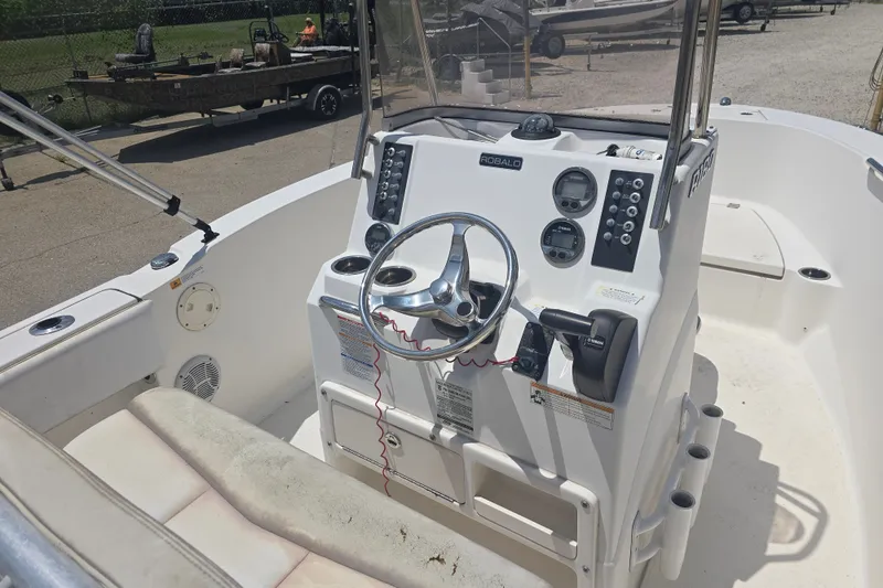 Slide: The Image of 2018 Robalo R180 Center Console boat interior with steering wheel and controls. - 11