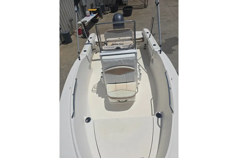 Slide: The Image of 2018 Robalo R180 Center Console boat with seating and steering console, docked outdoors. - 6