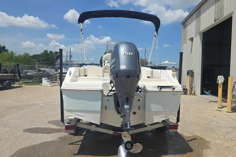 Slide: The Image of 2018 Robalo R180 Center Console boat with Yamaha 150 engine, parked outdoors. - 2