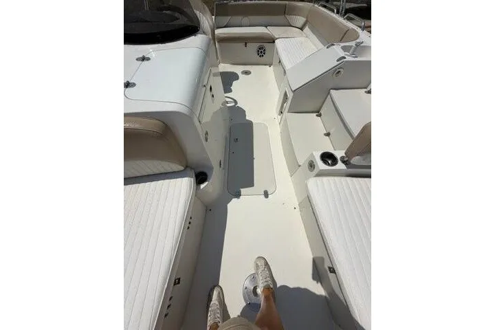 Slide: The Image of 2018 Stingray 212 SC boat interior with white seating and spacious layout. - 16