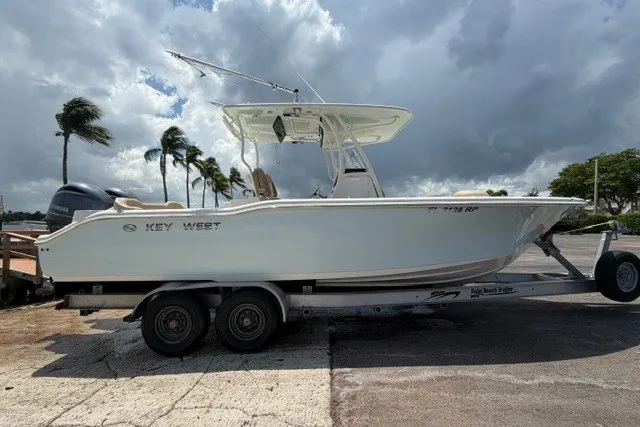 Slide: The Image of 2018 Key West 263 FS boat on trailer under cloudy sky. - 15