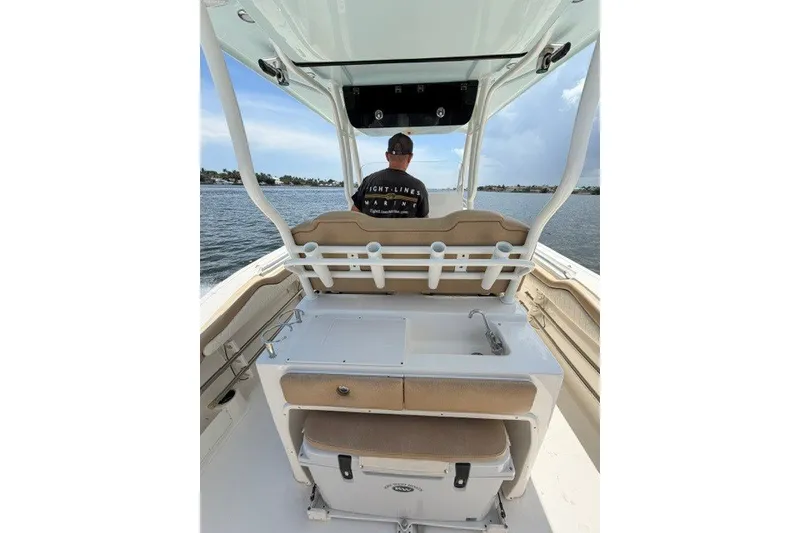 Slide: The Image of 2018 Key West 263 FS boat interior with helm and fishing setup on the water. - 9